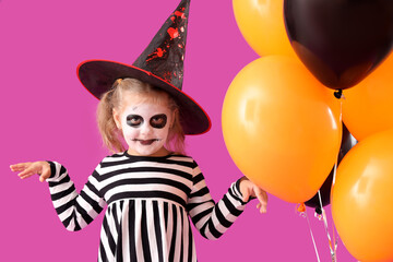 Poster - Little girl dressed for Halloween with balloons on purple background