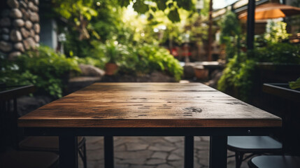 Wall Mural - Empty wooden table of a summer cafe on a background of beautiful green trees