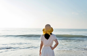 Wall Mural - Young woman having a rest on the beach.