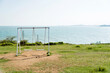 © xy - A couple of swings near the sea.