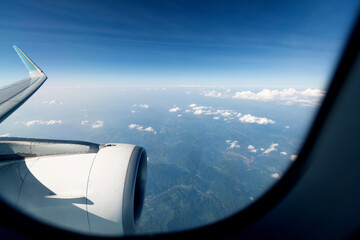 Canvas Print - Clouds and mountains view through airplane window