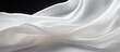White fabric cloth flowing on white background shown in close up