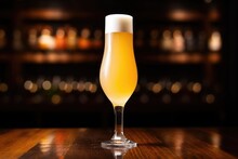 Pilsner Beer In A Tall, Slender Glass, Light Behind It