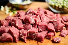 chopped garlic piled over raw marinated steak tips