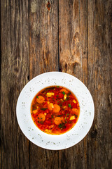 Tomato soup on wooden table