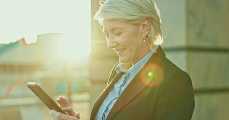 Wall Mural - Phone, senior woman and ceo in city, lens flare and sunset outdoor for vision. Mobile, thinking and happy business consultant in street reading email, social media and typing on app for communication