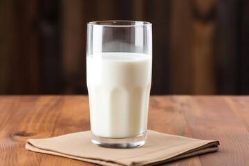 Wall Mural - full glass of milk on a wooden table