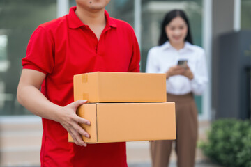 Asian people received product box from male delivery service person, modern e-commerce, home deliveries, convenient shopping experience, trustworthy doorstep service captured in moment.