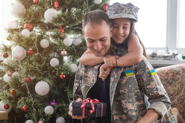 Wall Mural - Father in Ukrainian military uniform and his daughter. Family reunion