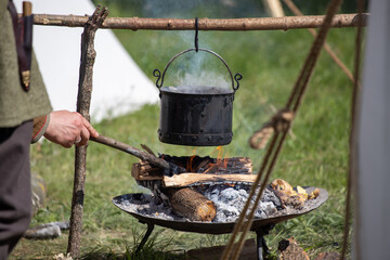 cooking over a fire while camping