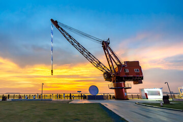 Wall Mural - Crane silhouette on the riverside