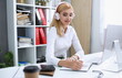 © H_Ko - Beautiful female student with headphones listening to music and learning. Hold the pen in his hand and looking at laptop monitor