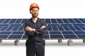 Canvas Print - Technician in a uniform with a helmet and goggles posing in front of photovoltaics