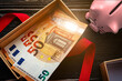 piggy bank and opened gift box with euro banknotes and red ribbon. top view. bonus bounty concept