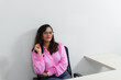© Thales - Portrait of a psychopedagogue, wearing pink clothes, in her office, sitting. Helps with school performance.
