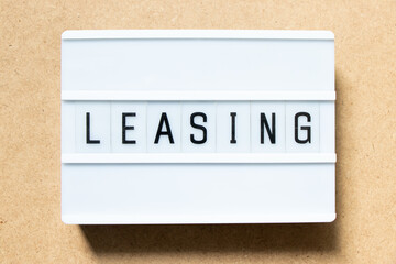 Sticker - Lightbox with word leasing on wood background