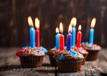 Birthday Muffin With Red And Blue Burning Candles On A Rustic Wooden Board Against A Dark Brown Background, Copy Space. Generative Ai