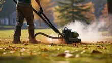 The Gardener Removes Old Dried Grass From The Lawn In The Park With A Gasoline Portable Blower. Lawn Care. Generative AI