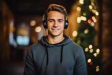 Portrait Of A Handsome Young Man Listening To Music With Headphones At Christmas Time