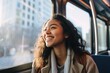 © Geber86 - Young happy woman looking out the window while riding on the bus