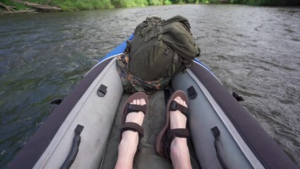 Canvas Print - The feet of a person kayaking down a river