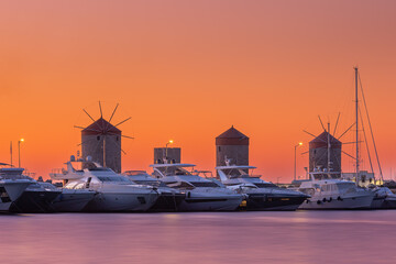 Wall Mural - Windmills in Mandraki harbor at sunrise, Rhodes Greece