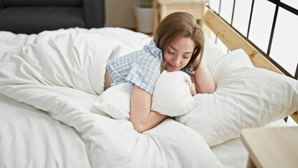 Sticker - Young blonde woman lying on bed sleeping at bedroom