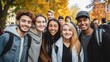 © Phoophinyo - Young people of various cultures smile at the camera. University students stand together on a college campus. Happy friends having fun together on a college campus. Friendship and way of life.