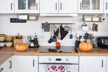 Wall Mural - Decor of the white classic kitchen with pumpkins for Halloween and harvest. Autumn mood in the home interior, modern loft style.