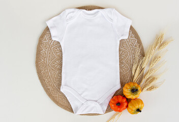 Wall Mural - Baby onesie flat lay on a halloween, pumpkins  background. Baby bodysuit mockup. Copy space for your design here. Top view. Flat Lay.	
