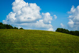 Fototapeta Góry - green hill blue sky white clouds