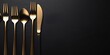 Set of stylish black and gold cutlery on black background. Dark and moody vibes. Fashionable and luxury eating. Flat-lay, top view. Copy space for your text. : Generative AI