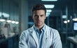 Handsome medical doctor in white lab coat is looking at camera