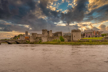 Canvas Print - King John castle in Limerick Ireland on the banks of the Shannon river with dramatic cloudy sunset sky