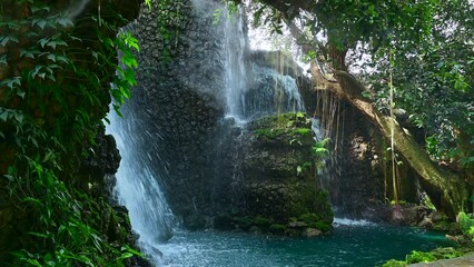 Wall Mural - Waterfall in a shady garden in Chiang Mai, Thailand.