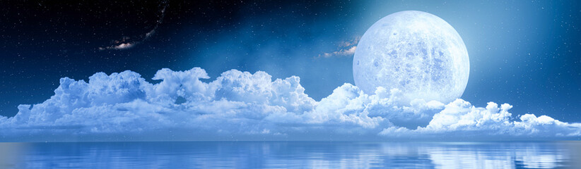 Wall Mural - the blue full moon is reflected in the sea. a wave of water from the ocean to the island. the sky ha