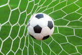 Fototapeta Młodzieżowe - soccer ball on goal with net background
