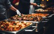 Catering buffet food indoor in restaurant or hotel with grilled meat and vegetables. Variety of street food. Group of people having lunch, banquet, festive event, party, or wedding reception.