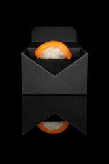 Poster - Sushi with salmon in a black box on a table with a reflection