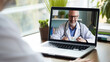 A patient video calls to inquire about medication use with the doctor via a laptop