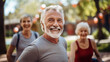 © EmmaStock - Elderly man exercising with friends in health park