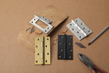 Installation of furniture hinges in chipboard. Small carpentry work in the workshop. light background,Installation of furniture hinges in chipboard in the workshop.dark background