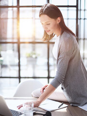 Business woman working on laptop computer in office