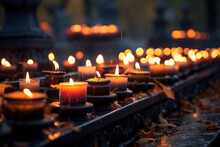Lots Of Lit Candles And Dry Autumn Leaves At The Cemetery. Celebrating All Saints Day At Graveyard At Night.