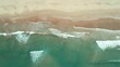 Top view of waves break on tropical white sand beach. Aerial drone view 4k shot of sea waves on the beautiful beach.