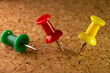 © DanieleRapo - group of red, green and yellow pins seen in macro stuck on a cork board