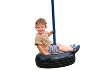 A Smiling Child Enjoys Playing On A Car Tire Turned Into A Swing, Isolated On White Background. A Happy Baby Is Spinning On A Swing Made Of A Tire From A Car Wheel. Kid Aged Two Years