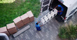 High Angle View Of Mover In Uniform Unloading Furniture