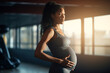 portrait pregnant african american woman in grey sportswear in gym, black expecting lady doing sport , Healthy lifestyle during pregnancy.