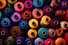 Spools Of Colorful Thread Sitting On Top Of One Another Piled Up And Ready To Be Used